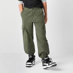 Keep his wardrobe fresh and on-trend with these Thereabouts little and big boys' cuffed cargo pants. They're made from cotton-poplin and feature a regular-fit, a flat front, two front slip pockets, two cargo side pockets, a button closure, and an elastic-back. Complete the look with a t-shirt and high-top sneakers. Front Style: Flat FrontClosure Type: Elastic Back, ButtonFit: Regular FitPockets: 2 Front Slip Pockets, 2 Cargo Side PocketsRise: At WaistBase Material: 97% Cotton, 3% SpandexFiber Co Cuffed Cargo Pants, Pants Cargo, Cargo Pant, Big Boys, Cotton Poplin, Kids Boys, Cargo Pants, High Top, Top Sneakers