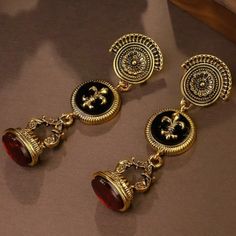 "Viena" Statement Earrings. Fleur De Lis Emblem. Colors: Gold, Black, And Deep Red. Luxe Gold Plated. Royal French Style. Baroque Jewelry, African Inspired Jewelry, Ancient Jewellery, Historical Jewellery, French Jewelry, Goth Jewelry, Jewelry Accessories Ideas, Italian Jewelry, Ancient Jewelry