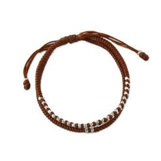 Braided cords in burnt sienna become a casual bracelet for men or women from Thai artisan Napapat. The artisan embellishes the bracelet with nugget-like beads of Karen hill tribe 950 silver. A sliding knot allows you to adjust the bracelet to the desired length. Adjustable Brown Jewelry With Silver Beads, Spiritual Brown Beaded Bracelets With Adjustable Cord, Bohemian Brown Bracelets With Silver Beads, Adjustable Hand-strung Brown Braided Bracelets, Brown Sliding Knot Bracelet For Friendship, Brown Sliding Knot Bracelets For Friendship, Brown Spiritual Braided Bracelets For Friendship, Spiritual Brown Braided Friendship Bracelets, Spiritual Brown Friendship Bracelets