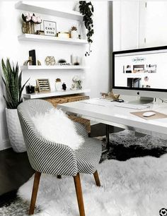 a white desk with a computer on it and a chair in front of the monitor