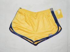 "Vintage 90s Rare New With Tags Running Tennis Short Shorts Authentic WILSON made in ITALY Good NEW VTG Condition. Yellow Colour with Blue details WASHED and SANITIZED Polyester Label Size : 44 . Adults'. Please to better fit read the measurements below. Elastic Waist 14 to 18 inch, 36 to 46 cm. Round Waist 36\". Lenght 8 inch , 20 cm. (on the side) Washed and sanitized. We Post from Italy This is a PRIVATE SALE The Photos are Real of the Items I sell in this auction. IF YOU HAVE QUESTION PLEASE Retro Stretch Bottoms In Short Length, Retro Stretch Bottoms Short Length, Retro Stretch Bottoms With Built-in Shorts, 90s Style Stretch Short Bottoms, Vintage Stretch Short Length Bottoms, Retro Yellow Short Bottoms, Yellow Retro Short Bottoms, Vintage Athletic Shorts For Summer, Fitted Yellow Athletic Shorts