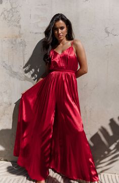 Pleated satin lends endless glamour to this party-ready wide-leg jumpsuit that dramatically sways with every stylish step you take. Hidden back-zip closure V-neck Adjustable straps Unlined 97% polyester, 3% spandex Hand wash, dry flat Imported Wedding Swimwear, Petal And Pup, Halter Neck Jumpsuit, Style Jumpsuit, Satin Jumpsuit, Soft Red, Red Jumpsuit, Satin Material, Red Satin