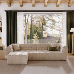 a living room with a couch and large windows