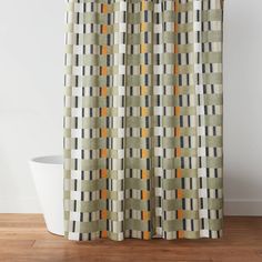 a shower curtain with an orange and grey checkered pattern