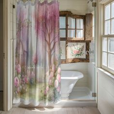 a bathroom with a shower curtain that has pink flowers on it and a white tub