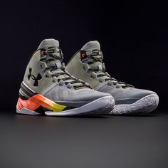 the under armour basketball shoe is shown in grey and neon yellow colors on a black background