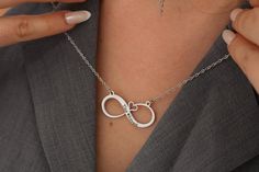 Embrace the timeless bond between mother and child with our Personalized Minimalist Infinity Necklaces. Crafted from durable stainless steel and featuring a waterproof design, these necklaces are a symbol of everlasting love and connection. The minimalist infinity pendant can be personalized with custom engraving, such as names, initials, or a meaningful date, adding a unique touch to this elegant piece of jewelry. Whether it's a Mother's Day gift, a birthday present, or a token of appreciation, Elegant Customizable Metal Necklaces, Nickel Free Stainless Steel Necklace For Anniversary, Nickel-free Stainless Steel Necklace For Anniversary, Nickel Free Stainless Steel Anniversary Necklace, Hypoallergenic Stainless Steel Necklace For Anniversary, Modern Infinity Necklace For Gift, Minimalist Stainless Steel Jewelry For Mother's Day, Minimalist Engraved Infinity Jewelry, Personalized Minimalist Infinity Necklace