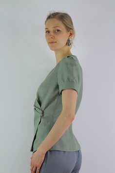 "Write the selected color in the message Handmade moss green linen blouse, perfect for casual wear and suitable for any occasion in any season Details: - 100% natural linen produced in Europe ; - medium weight (180 gram per square meter); - color: moss green, could be any from our colors catalog (color samples at the photo); Made to order, approximately a few days, If you have any questions please message me and I will be glad to answer. Size guide : Size XS Bust: fits bust around 33\"-34\"/ 84- Green Linen Blouse For Workwear, Green Linen Short Sleeve Blouse, Chic Green Linen Top, Elegant Green Linen Top, Linen Tops With Roll-up Sleeves, Fitted Linen Wrap Blouse, Chic Fitted Linen Wrap Top, Collared Linen Top With Roll-up Sleeves, Oversized Linen Top With Roll-up Sleeves