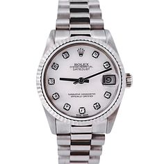 Women's Midsize Rolex 31mm DateJust 18K White Gold Watch with Pink Diamond Dial and Fluted Bezel. Pre-Owned SN# N11**** Brand: Rolex. Gender: Ladies. Dial Color: Pink. Crystal: Sapphire. Dial: Diamond Dial. Model Number: 68279. Bracelet / Strap: Jubilee. Metal Type: 18K White Gold. Case Dimensions: Midsize 31mm. Movement: Self-Winding (Automatic). Box / Certificate: Rolex Box / Certificate of Authenticity. Service Warranty: One (1) Year Limited Service Warranty. Rolex 31mm Datejust, Corum Watches, White Gold Watch, Patek Philippe Mens, Chopard Watch, Zenith Watches, Rolex Watches Women, Rolex Women, Hublot Watches