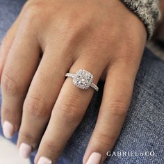 a woman's hand with a diamond ring on it