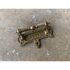 an antique brass door handle with the word express on it's side and two keys attached