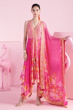 Hot pink, multicolor asymmetric kurta with blossom cluster print and cutdana, bead embroidery. Paired with printed dhoti pant and tassel bordered dupatta. - Aza Fashions Sleeveless Pink Anarkali Set For Festivals, Designer Sleeveless Pink Anarkali Set, Bollywood Style Pink Sleeveless Palazzo Set, Sleeveless Palazzo Set With Sheer Dupatta For Festivals, Pink Sleeveless Anarkali Set For Festive, Pink Bollywood Style Sleeveless Palazzo Set, Pink Sleeveless Bollywood Anarkali Set, Pink Sleeveless Bollywood Palazzo Set, Pink Sleeveless Salwar Kameez With Resham Embroidery