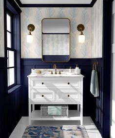 a bathroom with blue and white wallpaper, two sinks and a gold framed mirror