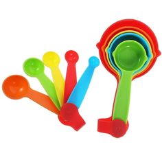 colorful plastic spoons and measuring cups on a white background