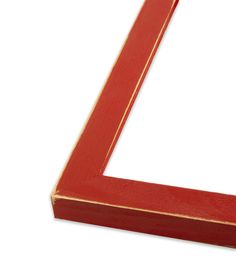 a red wooden frame sitting on top of a white surface