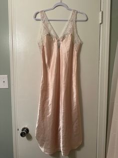 This is such a pretty feminine nightgown! You will be so beautiful in this one! It's soft and silky, the lace and the flower details add such a girly touch to it!  It's just gorgeous!  There is one teeny tiny mark, looks like a pen mark, see picture, you can barely notice it! Bedtime Lace Slip Dress With Lace Trim, Feminine Pink Slip Dress For Sleepover, Pink Delicate Lace Sleepwear, Pink Satin Slip Dress For Sleepover, Pink Slip Dress For Spring Sleepover, Pink Camisole Slip Dress For Bedtime, Pink Delicate Lace Nightgown For Sleep, Pink Delicate Lace Nightgown, Pink Lace Camisole Nightgown