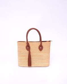 Do you want to look stylish and hippy? Get your hands on this handmade straw bag. It's high quality, eco-friendly, and handcrafted by women in Morocco. Its design is unique and timeless. Get yours now! we are proud to introduce our signature straw french bag to you. it is handmade by our talented artisan who has been working with us for years. this beautiful bag has a unique design that you would find nowhere else. the light and durable material are ideal for taking the bag on your adventures. S Beach Shoulder Bag With Tassels, Rectangular Shape, Tasseled Straw Shoulder Bag, Casual Rectangular Crochet Bag With Tassels, Rectangular Beach Bag With Tassels For Summer, Bohemian Bucket Bag With Tassels For Beach, Rectangular Summer Beach Bag With Tassels, Summer Straw Shoulder Bag With Tassels, Rectangular Straw Beach Bag With Tassels, Rectangular Straw Bag With Tassels For Beach