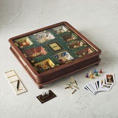 a wooden box filled with lots of cards and magnets on top of a table