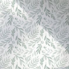 the wall paper has green leaves and berries on it, as well as a white background