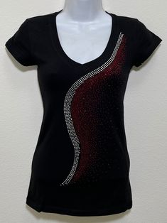 Fabric is comprised of 95% cotton and 5% spandex.  Handmade rhinestone t-shirts made in the United States with quality rhinestones. Machine washable. T-shirt style is a fitted V-neck cap sleeve. Size Range:         XXS = 2         XS = 4         S = 6         M = 8         L = 10         XL = 12 Fitted Black T-shirt With Rhinestones, Cotton Short Sleeve Top With Rhinestones, Fitted Cotton Embellished T-shirt, Rhinestone Cotton Tops With Short Sleeves, Embellished Fitted Cotton T-shirt, Cotton Tops With Rhinestones And Short Sleeves, Cotton Rhinestone Short Sleeve Top, Fitted Cotton Top With Rhinestones, Fitted Black Embellished T-shirt