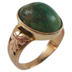 Victorian Turquoise and 18K yellow gold cocktail ring - hand made - featuring a milgrain set natural oval cabochon Turquoise (approx. 8.73 carats - 14 x 11 x 7.5 mm.) - the shoulders with applied acanthus leaf details - open setting from the back - warm aged patina - acid tested for metal purity - no hallmarks - United Kingdom - circa 1900. Excellent antique condition - all original - no loss - no damage - no repairs - signs of age and use - ready to wear. Ring Size - 7.0 (U.S.). Ring Size / Dim