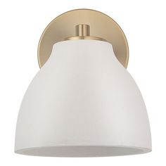 a light fixture with a white shade on the top and gold trim around the bottom