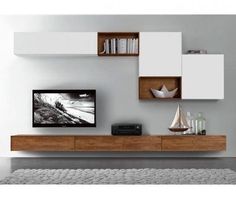 a living room filled with furniture and bookshelves next to a wall mounted tv