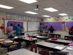 an empty classroom with students writing on the chalkboard