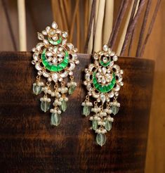 🌟 Experience the Essence of Indian Tradition with Our Handcrafted Kundan Chandbali Earrings! 🌟 💫 Stunning Design: Embrace the allure of Indian craftsmanship with our exquisite Kundan Chandbali Earrings. Handmade by skilled artisans, each piece is a testament to timeless beauty. 🪙 High-Quality Materials: Crafted from a blend of silver and copper, adorned with radiant green and golden Kundan stones, and finished with a lustrous 22k gold plating(Nickel Free), these earrings exude elegance and s Chandbali Earrings Kundan, Kundan Chandbali, Polki Sets, Earrings Kundan, Rajputi Jewellery, Earring Bridal, Pakistani Bridal Jewelry, Best Gift For Wife, Bali Jewelry