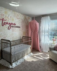 a baby's room with a crib, chair and window