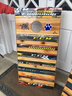 a large wooden board game made out of skis and snowboards with an animal sticker on it