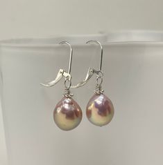 Baroque Pearl Earrings. Silver Leverback Earrings. Sterling Silver Earrings. Handmade earrings using baroque freshwater pearls (nucleated) and sterling silver components. These gorgeous pearls are lavender in color with nice luster and sunset overtones. The pearls are baroque shaped and approximately 12.2 x 10 (H x W) mm in size. The earrings, accented by sterling silver Bali daisies and mounted with simple lever back earring wires, measure 1 5/16 inches (3.4 cm) in length. Pearl is the birthsto Gift Pearl Earrings With French Hook, French Hook Pearl Drop Earrings For Gift, Teardrop Pearl Earrings With Lever Back For Gift, Handmade Teardrop Pearl Earrings For Anniversary, Handmade Adjustable Teardrop Pearl Earrings, Lavender Teardrop Earrings With Ear Wire, Silver Pearl Earrings With French Hook For Gift, Silver Pearl Earrings With French Hook As Gift, Pearl Drop Earrings Gift