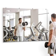 a man standing in front of a mirror with dumbs on his shoulders and another man looking into the mirror