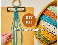 a hand holding a piece of yarn next to a clipboard with the words diy kit on it