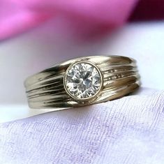 a close up of a ring with a diamond on it