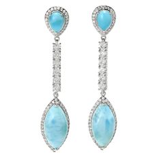 Radiate eye-catching sparkle and shine from your lobes with these magnificent 1.59 carat Gem Treasures dangle earrings. You'll love the way they frame your face in gorgeous color and style as they dance in the light with your every movement. Each 2.5" earring showcases 16x8mm marquise-shaped and 7x5mm pear-shaped larimar gemstones. There's also dazzling white zircon halos around the larimar and a line of six white zircons connecting the two larimar gems. The pair is finely crafted in sterling si Larimar Earrings, Jewelry Cleaning Solution, Sparkle And Shine, Blue Gems, Pure Silver, Pear Shaped, Wedding Jewelry, Halo, Pear