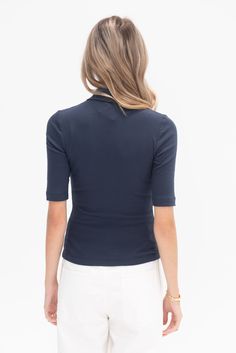 polo collar elbow-length sleeves front button placket fitted silhouette 100% gots cotton made in usa model is wearing smodel is 5’11", a us 4 and s in tops