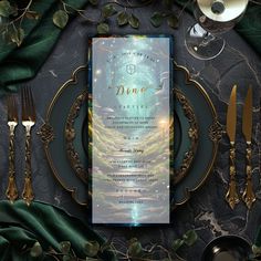 a table setting with place settings and silverware on it, along with green leaves