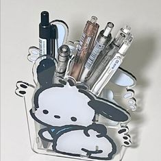 a pen holder with pens, pencils and other office supplies in the shape of a cartoon character