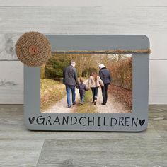 an old photo frame with the words grandchildren and two people walking down a path