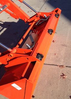 an orange truck bed sitting on top of a sidewalk