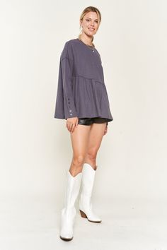 One comfy knit top to rule them all. This waffle knit babydoll beauty is about to become your new best friend. With dropped shoulders, long sleeves and an oversized silhouette, it’s a cozy-chic fit that flatters in all the right places. Button-tab details on the sleeves add a dash of panache. Whether you’re curling up on the couch with a good book or heading out for a night on the town, this top is ready to play whatever role you need. Effortlessly stylish yet wonderfully practical, it layers li Trendy Long Sleeve Top For Loungewear In Fall, Trendy Long Sleeve Top For Fall Loungewear, Trendy Waffle Knit Tops For Fall, Chic Waffle Knit Tops For Fall, Relaxed Fit Waffle Knit Tops For Fall, Oversized Waffle Knit Tops For Fall, Chic Waffle Knit Loungewear Top, Oversized Long Sleeve Waffle Knit Top, Last Shot