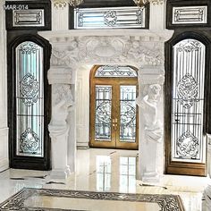 an ornate entryway with marble statues and stained glass doors in the center, surrounded by white marble flooring