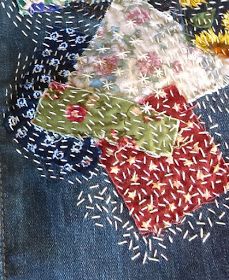 an old pair of jeans has been stitched together with different colored fabrics and threads