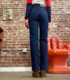 "70s Dark Wash Ultra High Waist Denim Straight Leg Jeans Beautiful seventies ultra high waist dark wash denim strait leg jeans. Orange top stitching. Fantastic detail on the back pockets. Zipper fly with a snap button closure at the waist. These are hot! In perfect condition. By Fort Dodge 26\" waist 31\" inseam 34\" hip 11\" rise in front 13.5\" rise in back 17\" circumference of hem Model is 5' 5\" 25\" waist 32\" hip Feel free to message me with any questions. I'm happy to help and quick to r Retro Fitted Dark Wash Flare Jeans, Fitted Dark Wash Jeans With Contrast Stitching, Retro Fitted Flare Jeans With Five Pockets, Vintage Straight Leg Flare Jeans For Fall, Vintage Dark Wash Pants For Fall, Vintage Fall Flare Jeans, Fitted Rigid Denim Flare Jeans In Dark Wash, Fitted Dark Wash Flare Jeans With Contrast Stitching, Fitted Dark Wash Flare Jeans In Rigid Denim