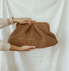 Trendy raffia Pelmeni clutch bag with soft, voluminous pleats that completely hide the model's frame, giving it a rounded shape. A model for stylish women living in big cities, for whom practicality is as important as beauty. Take her to work in the office or to deal with everyday worries. Closes with magnets. Inside: one compartment inside. Cloud bag is available to order in Size: XL: Height  - 9.05 inches (23 cm) Width of the bag itself is  - 17.71 inches (45 cm) Depth - 7.87 inches (20 cm) * Brown Leather Clutch With Braided Handles For Daily Use, Brown Pouch Clutch With Braided Handles, Elegant Summer Straw Bag With Removable Pouch, Chic Brown Travel Clutch, Travel Clutch With Braided Handles, Elegant Brown Straw Bag For Spring, Brown Straw Bag With Removable Pouch For Spring, Chic Summer Clutch With Removable Pouch, Chic Straw Clutch With Braided Handles