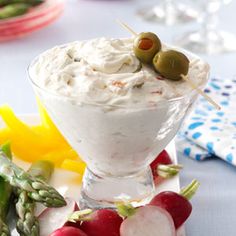 there is a dessert with strawberries and cream on the table next to other food items