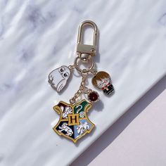 a harry potter house keychain on a marble surface