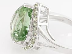 7.57ct heart shape Brazilian prasiolite with .51ctw round green sapphire rhodium over sterling silver ring. Measures approximately 11/16"L x 1/16"W. Not sizeable. Hallmarked Green Sterling Silver Diamond Ring, Green Sterling Silver Gemstones With Polished Finish, Green Sapphire Ring Sterling Silver, May Birthstone, Green Polished Sterling Silver Gemstones, Prasiolite Ring, Silver Heart Ring, Broken Chain, Pearl Strands, Green Sapphire