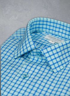 The dreamy feel of the super soft Alexander in Aqua Blue Plaid Shirt evokes the relaxed Mediterranean lifestyle, with its shimmering shades of Blue. Deliberately detailed with well-thought-out accoutrements such as matching blue buttons and button threads lend a custom look to this beautiful shirt. Can be dressed up under a blazer or worn untucked, for a more casual, after-hours look. The Alexander is the trimmest of all our fits, calibrated to accentuate a lean, athletic body type. • Trimmest F Light Blue Tops With Button Cuffs And Spread Collar, Light Blue Summer Tops With Button Cuffs, Blue Top With Button Cuffs And Spread Collar, Blue Dress Shirt With Button Cuffs For Spring, Light Blue Formal Tops With Button Cuffs, Light Blue Formal Top With Button Cuffs, Formal Light Blue Tops With Button Cuffs, Summer Light Blue Dress Shirt With Button Closure, Fitted Blue Tops With Button Cuffs